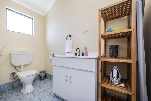 a bathroom with a toilet and a sink at Windsurfer Beach House in Lancelin
