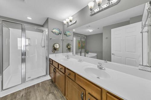 a bathroom with a tub and a shower and a sink at Ariel Dunes II 1301 in Destin