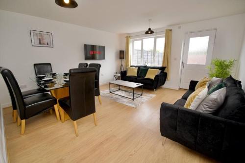a living room with a couch and a table at Highley's Nest - Fully Furnished Gem, Free Private Parking, Sky TV & Netflix in Coventry
