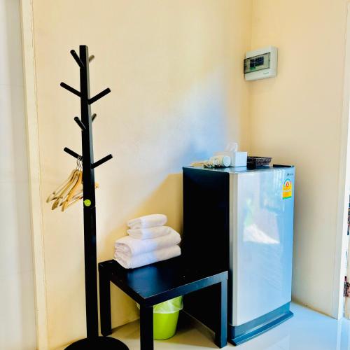 a bathroom with a black table with towels and a cross at BLUE OCEAN kohlarn resort in Ko Larn