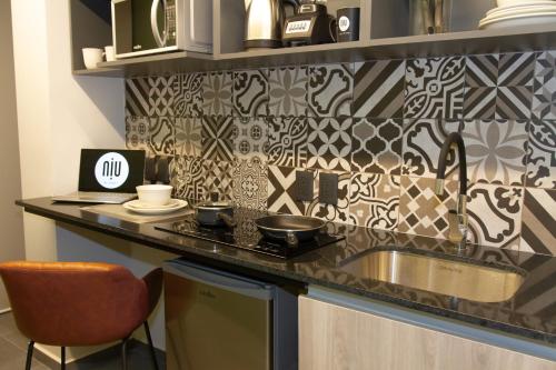 a kitchen with a counter with a sink and a counter top at NIU Reforma in Mexico City