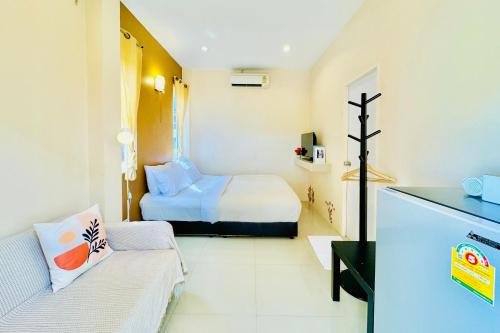 a small room with a bed and a couch at BLUE OCEAN kohlarn resort in Ko Larn