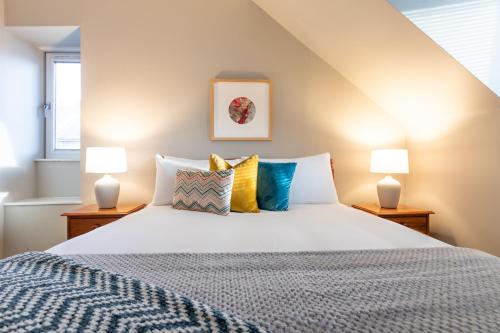 a bedroom with a large bed with two lamps at Sweet Ness River Flat, Inverness City in Inverness