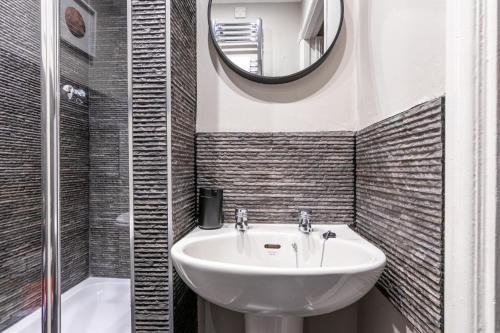 a bathroom with a sink and a mirror at Sweet Ness River Flat, Inverness City in Inverness