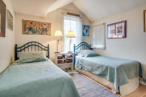a bedroom with two beds and a window at Beautiful Aquinnah Home Ocean View, Walk to Beach in Lobsterville