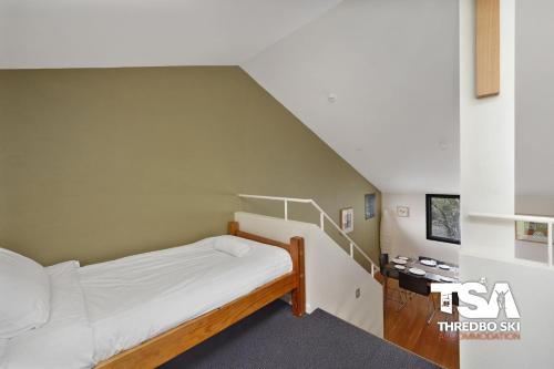 a bedroom with a bunk bed and a staircase at Oberdere 2 in Thredbo