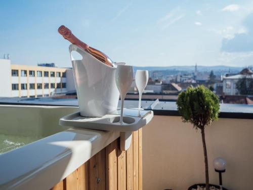 two utensils sitting on a ledge on a balcony at GAVAS Jacuzzi Relax Zen in Cluj-Napoca