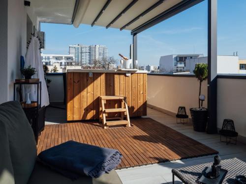 a small balcony with a wooden island on a roof at GAVAS Jacuzzi Relax Zen in Cluj-Napoca