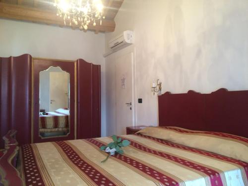 a bedroom with two beds and a mirror in it at B&B Cittabella in Cittadella
