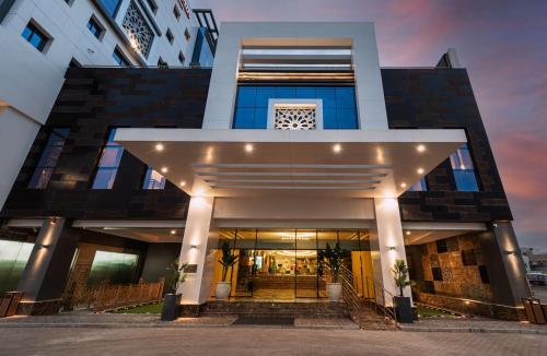 a building with a staircase in front of it at Best Western Plus Tabuk City Center in Tabuk