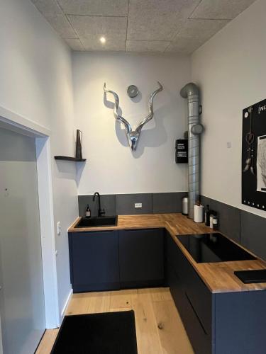 a kitchen with a sink and a counter top at Ekslusiv lejlighed in Herning