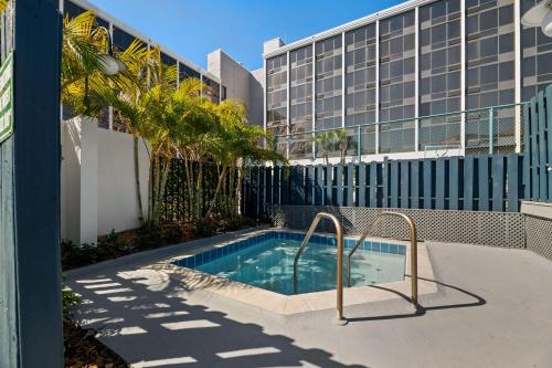 a swimming pool in front of a building at Best Western Orlando Gateway Hotel in Orlando