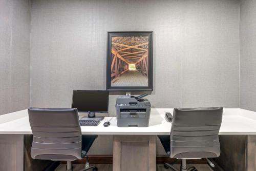 an office with a desk with a computer and two chairs at Best Western Plus Owensboro in Owensboro