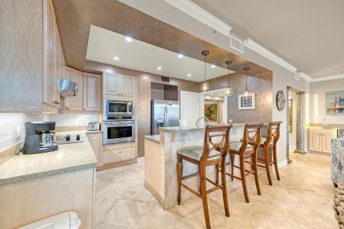 a kitchen with a counter and a bar with chairs at Majestic Sun 1205B in Destin