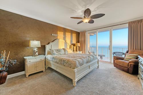 a bedroom with a bed and a balcony with the ocean at Majestic Sun 1205B in Destin