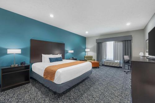 a hotel room with a large bed and a desk at Best Western Plus Owensboro in Owensboro