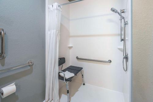 a bathroom with a shower and a stool in it at Best Western Plus Owensboro in Owensboro
