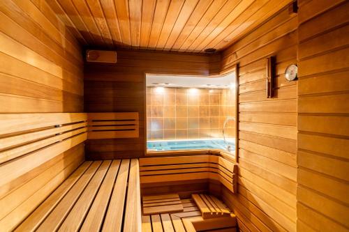 a sauna with a window and a tub at Pension Slunečnice & Panorama Restaurace Farma in Špindlerův Mlýn