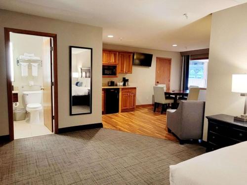 a living room with a kitchen and a dining room at Best Western Plus Dubuque Hotel and Conference Center in Dubuque