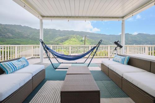 a porch with a hammock and a view of the mountains at Rainbow Escape & Bungalow in Honolulu