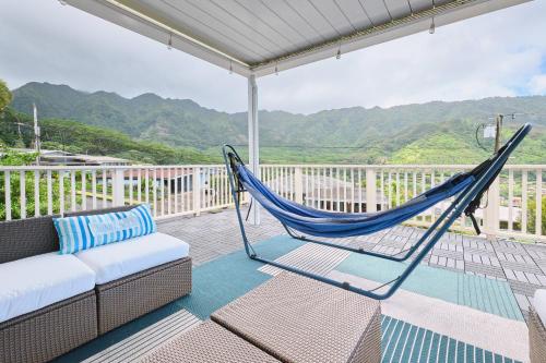a hammock on a balcony with a view of the mountains at Rainbow Escape & Bungalow in Honolulu