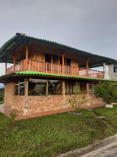 a house with a deck on top of it at Cabaña Pavachoque in Puente Nacional