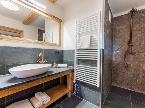 a bathroom with a sink and a mirror at AlmApARTment Mauterndorf Pichl 7-3 in Mauterndorf