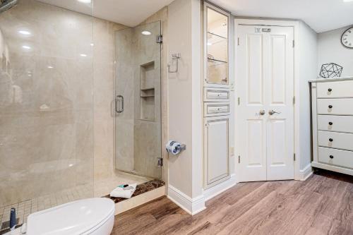 a bathroom with a shower and a toilet and a sink at Shoreline Towers 3094 in Destin