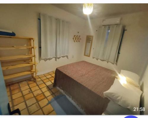 Postel nebo postele na pokoji v ubytování CASA PARRACHO Maracajaú