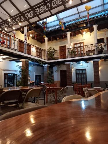 a restaurant with tables and chairs and a balcony at San Sebastian in Comitán