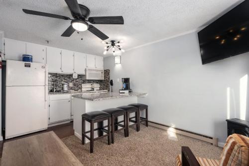 a kitchen with white appliances and a ceiling fan at Stroll to Slopes, Village Area, Ski in-out MtLodge 219 in Snowshoe