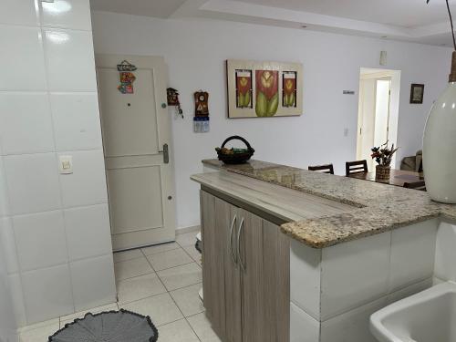 eine Küche mit einer Spüle und einer Arbeitsplatte in der Unterkunft Maravilhosa Cobertura Apto com Vista para o Mar - Praia da Enseada em Ubatuba in Ubatuba