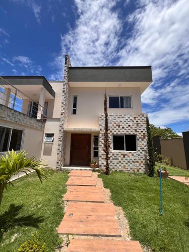 a house with a pathway in front of it at Casa Paraiso de Praia in Porto Seguro