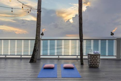 two blue yoga mats on the deck of a resort at Waves Resort & Spa, Barbados, An Autograph Collection All-Inclusive Resort in Saint James