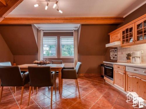 a kitchen with a table and chairs in a room at Maisonette holiday apartment Fichtelberg in Annaberg-Buchholz