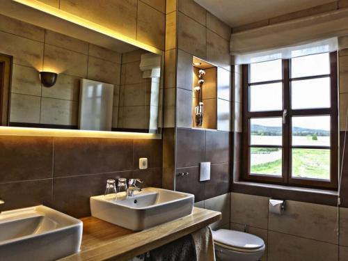 a bathroom with two sinks and a toilet at Inviting apartment in Zell in Oppurg