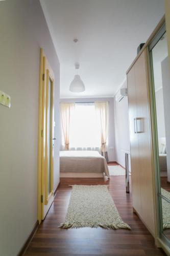 a bedroom with a bed and a large window at Tulipan Hotel Aquapark in Vyshkove