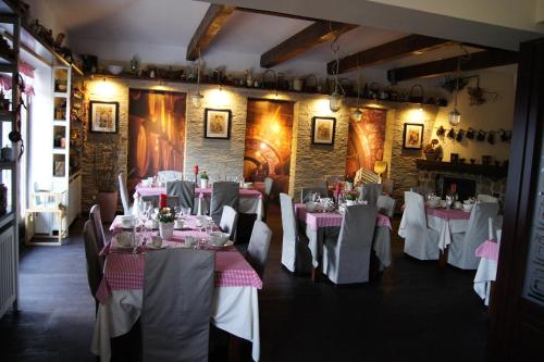 a dining room with tables with white tablecloths at Biały Bór Rooms in Grudziądz