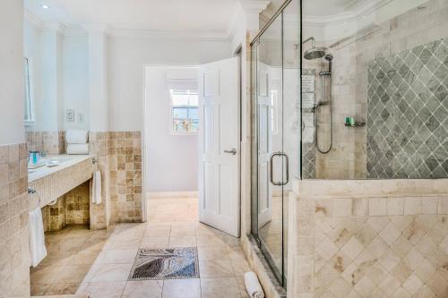 a bathroom with a shower with a glass door at Treasure Beach by Elegant Hotels - All-Inclusive, Adults Only in Saint James