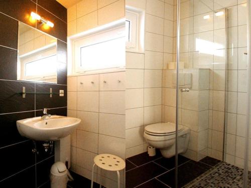 a bathroom with a toilet and a sink at Lovely apartment in Immenstadt in Zierow