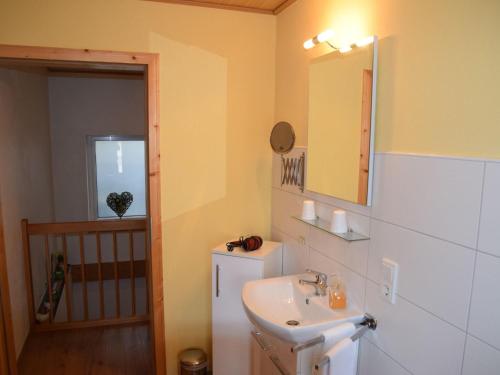 a bathroom with a sink and a mirror at Holiday home in Wilsecker with private terrace 