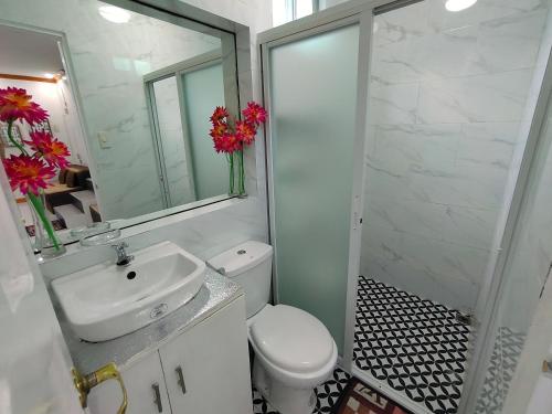 a bathroom with a sink and a toilet and a mirror at Private 2-Floors Bedroom near DVO Airport in Davao City