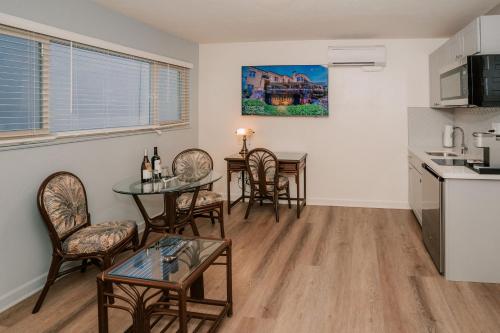 a living room with a table and chairs and a kitchen at Pantai Inn in San Diego
