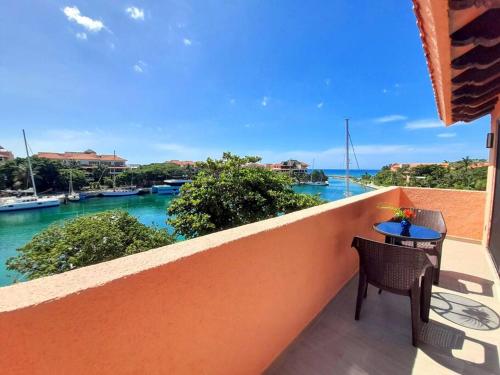 a balcony with a table and a view of the water at Penthouse, Ocean & Marina vws, Great 4 Remote Work in Puerto Aventuras