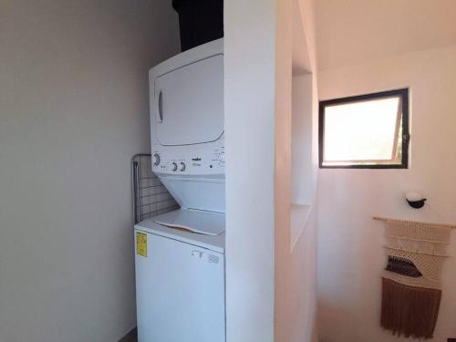 a white refrigerator with a microwave on top of it at Penthouse, Ocean & Marina vws, Great 4 Remote Work in Puerto Aventuras