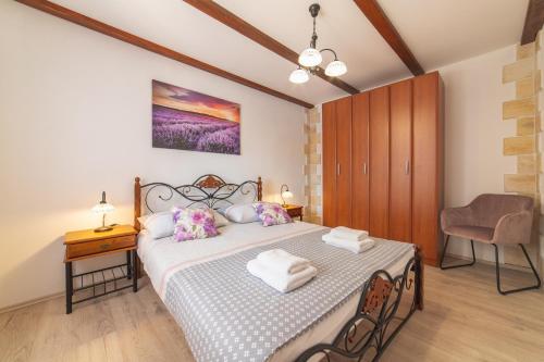 a bedroom with a bed and a table and a chair at Family friendly house with a swimming pool Veliki Brocanac, Zagora - 22666 in Klis