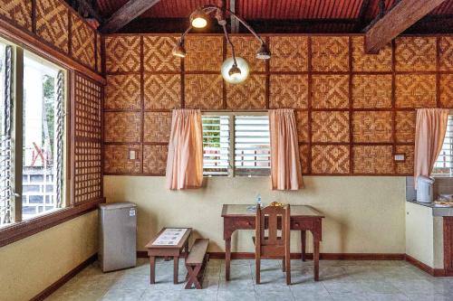 a dining room with a table and a window at Golda Coast Resort - Oslob in Oslob