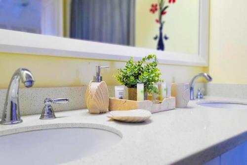 a bathroom counter with two sinks and a mirror at "LuxuryCrest , King Bed, BBQ & Backyard Games, Near Ocho Rios" in Ocho Rios