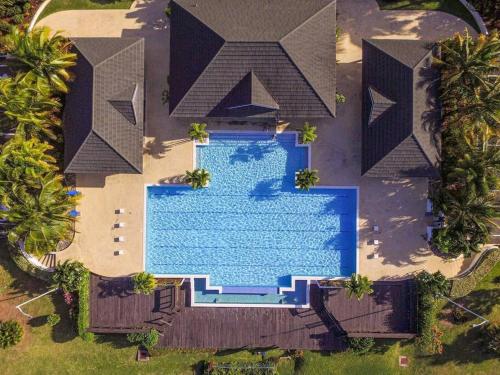an overhead view of a swimming pool in front of a house at "LuxuryCrest , King Bed, BBQ & Backyard Games, Near Ocho Rios" in Ocho Rios