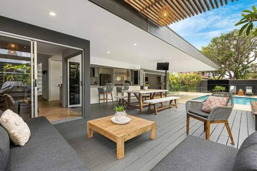 a living room with a couch and a table at Zinc Casuarina in Casuarina